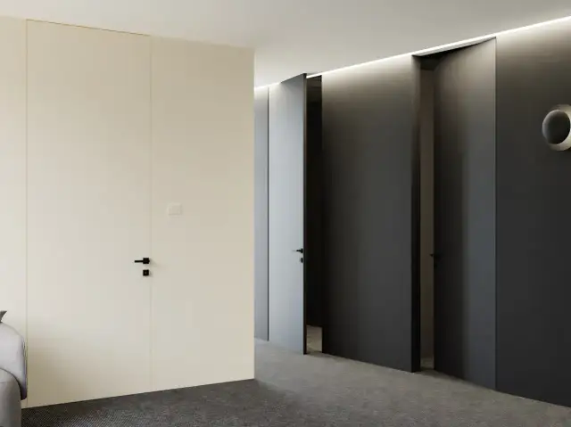 Korytarz z drzwiami w odwróconej przylgi, jedna jasna, dwie ciemne, minimalistyczne, nowoczesne wnętrze.