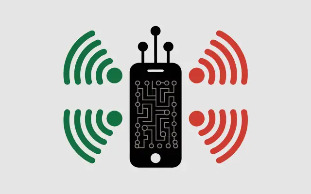 Smartphone noir avec circuit imprimé, entouré de signaux verts et rouges. L'iPhone 11 est-il 5G ou pas ?