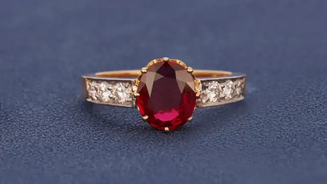 Ein Ring mit einem ovalen, tiefroten Edelstein, der an einen Rubin erinnert. Der Unterschied zwischen Granat und Rubin ist oft die Farbe.