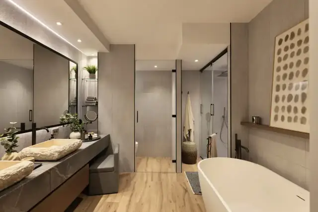 Elegante baño moderno con lavabos de piedra natural, bañera exenta y ducha acristalada. La decoración baños combina texturas y tonos neutros.