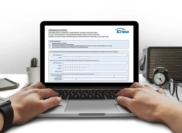 Laptop z otwartym formularzem "Oświadczenie" i rękami użytkownika wpisującymi dane.