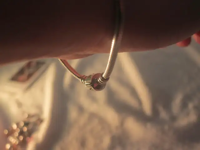 Zbliżenie na bransoletkę Pandora z zapięciem na nadgarstku.