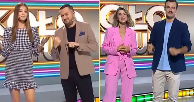 Iza Krzan w Kole Fortuny w różowym garniturze, obok niej prowadzący w eleganckich strojach.