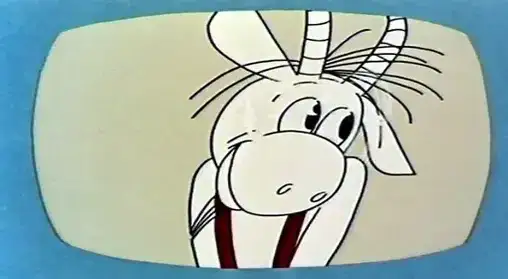 Koziołek Matołek w wierszu, z rogami i w szelkach, patrzy z ekranu.