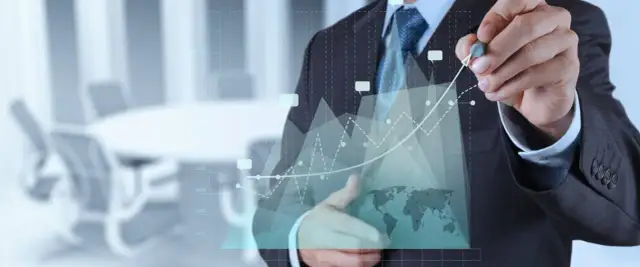 Biznesmen analizuje wykresy, pokazując przykłady procedur ISO. W tle sala konferencyjna.