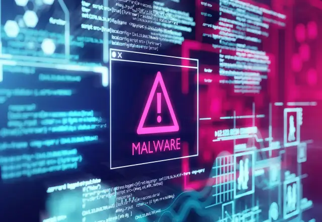 Okno z ostrzeżeniem o zagrożeniu MALWARE. W tle widać kod i schematy, sugerujące jak usunąć malware.