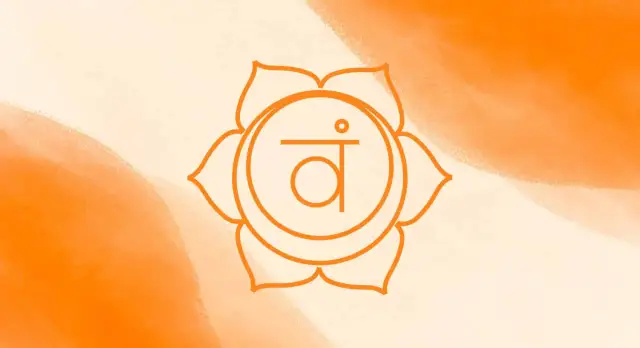 Pomarańczowy symbol czakry podstawy na tle z rozmytymi plamami w kolorze pomarańczowym.