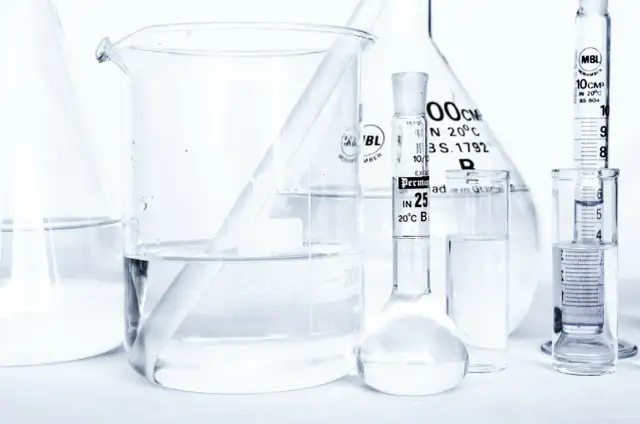 Laboratorium z kolbami i zlewkami, w których znajduje się płyn, być może butylene glycol, gotowy do analizy.