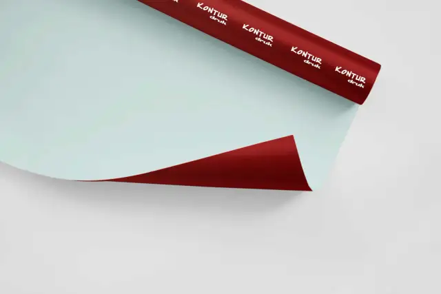 Rolka czerwonej folii samoprzylepnej z białym logo "KONTUR druk" na jasnoniebieskim tle.