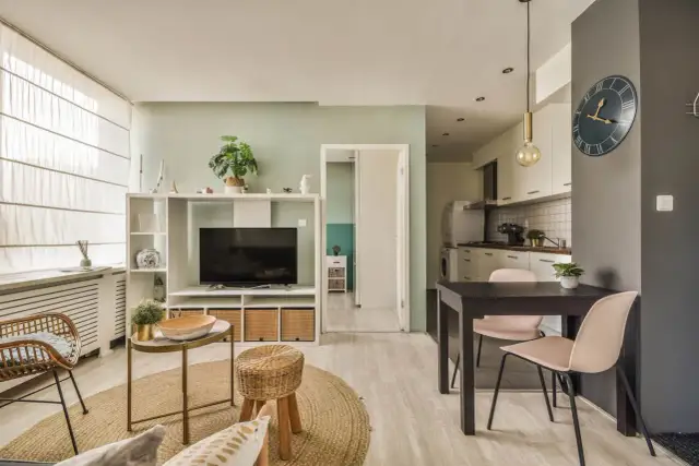 Stylowa aranżacja kawalerki 27m. Jasny salon z TV, przytulna jadalnia i funkcjonalna kuchnia.