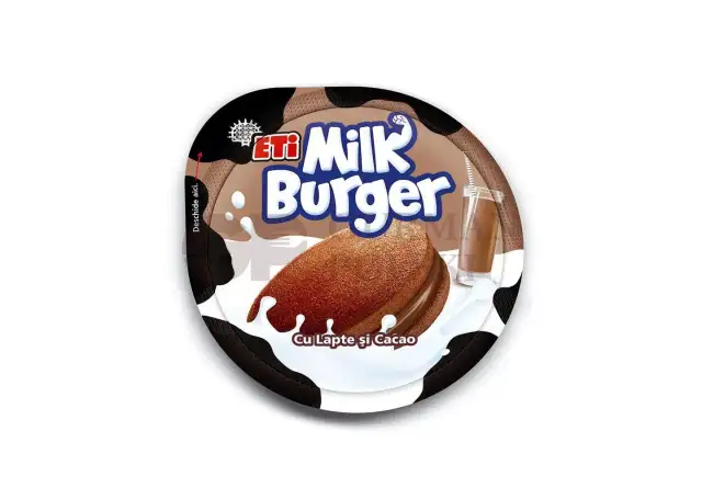 Czekoladowe ciastko Milk Burger z kremem, oblane mlekiem, obok szklanki mleka czekoladowego.