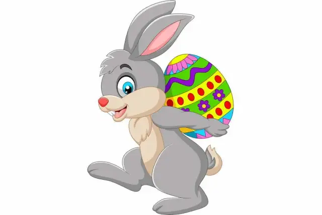 Wesoły zajączek z kolorowym jajkiem na plecach. Czy to dlatego zajączek jest symbolem wielkanocy?
