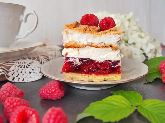 Sernik z malinami i bezą, idealny na letnie popołudnie. Jak suszyć bezę do malinowej chmurki? Oto inspiracja!