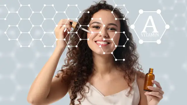 Kobieta z serum na twarzy, symbolizującym, jak działa retinol. W tle grafika przedstawiająca cząsteczki i witaminę A.