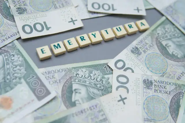 Pieniądze i litery układające się w słowo "EMERYTURA". Zastanawiasz się, ile wynosi minimalna emerytura w Polsce?