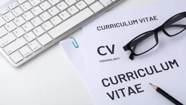 Klawiatura, okulary i dokumenty CV. Zastanawiasz się, gdzie w cv wpisać prawo jazdy? Najlepiej w sekcji "Umiejętności" lub "Dodatkowe informacje".