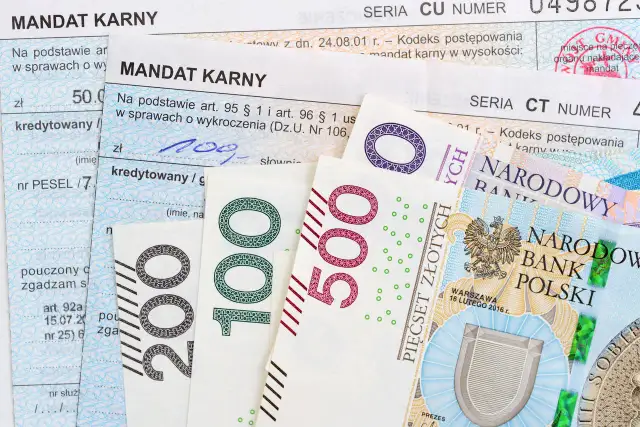 Mandaty karne i polskie banknoty 100, 200, 500 zł. Jak zapłacić mandat mBank? Dokumenty i pieniądze na stole.