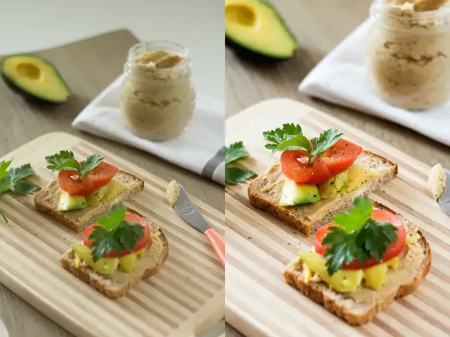 Dwa tosty z awokado, pomidorem i pietruszką na desce, obok słoiczek pasty i nóż.
