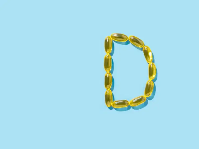 Żółte kapsułki ułożone w literę "D" przypominają o tym, kiedy brać witaminę D dla zdrowia kości i odporności.