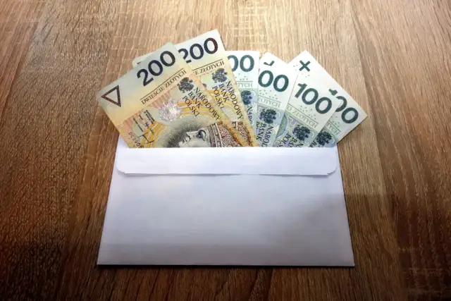 Koperta z banknotami 200 zł i 100 zł. Zastanawiasz się, ile pieniędzy daje się na osiemnastkę?
