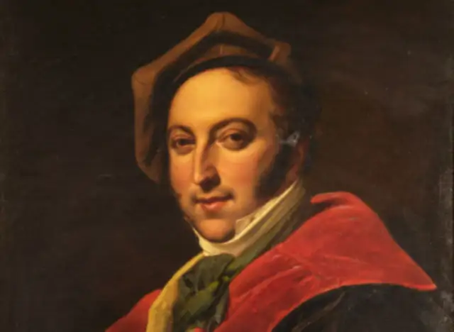 Portret Gioacchino Rossiniego w czerwonej todze i brązowym kapeluszu.