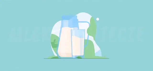 Dzbanek i szklanka mleka na tle zieleni. Czy mleko jest lekkostrawne? To pytanie nurtuje wielu.