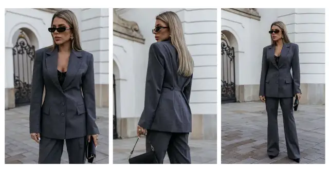 Elegancka kobieta w szarym garniturze, prezentująca styl minimalistyczny ubiór. Czarna koronkowa bluzka i okulary dodają charakteru.