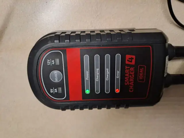 Prostownik samochodowy z diodami informującymi o stanie ładowania: Power (zielona), Error (czerwona).