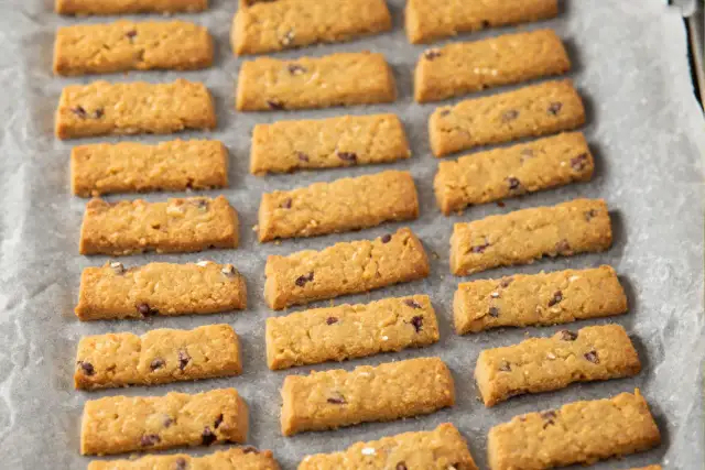 Ciasteczka Belvita na papierze do pieczenia. Czy ciastka Belvita są zdrowe? Te złociste, prostokątne herbatniki z kawałkami czekolady i owoców wyglądają apetycznie.