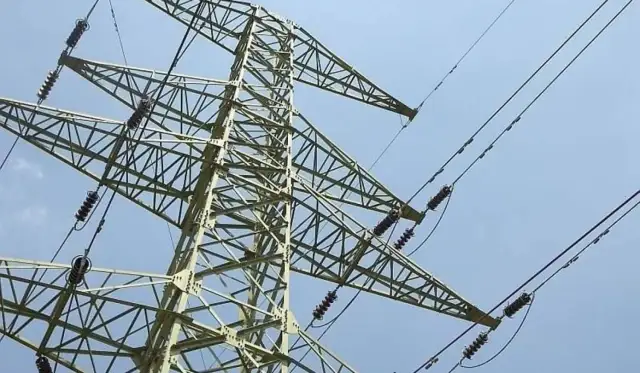 Wysoki maszt energetyczny z przewodami, przypominający o konieczności zachowania bezpieczna odległość od linii wysokiego napięcia 400 kv.