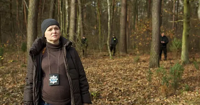 Jowita Budnik w lesie, w jednym z filmów, w roli policjantki. W tle inni funkcjonariusze.