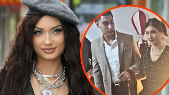 Viki Gabor w eleganckim stroju, obok niej mężczyzna w garniturze, być może jej mąż.