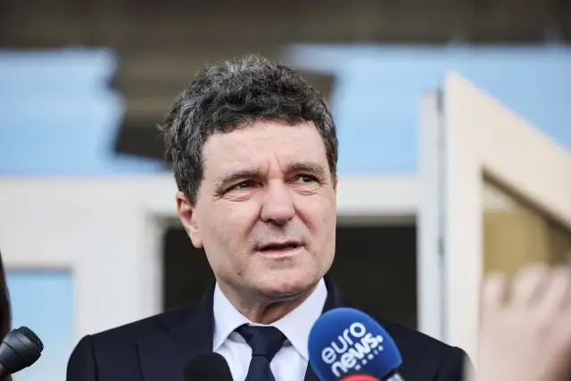 Prezydent Rumunii w garniturze odpowiada na pytania dziennikarzy, mikrofon Euro News w kadrze.