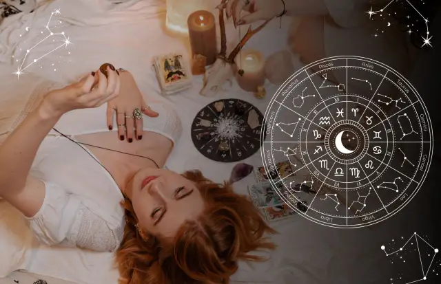 Kobieta z rudymi włosami leży na łóżku, trzymając w dłoni kamień. Obok niej talia kart, świece i koło zodiaku. 19 października znak zodiaku to Waga.