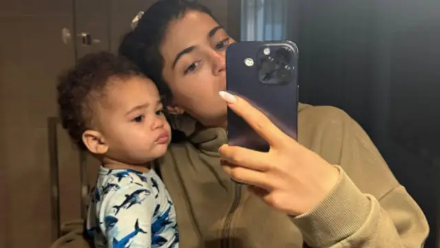 Kylie Jenner z jednym ze swoich dzieci, robiąc selfie.