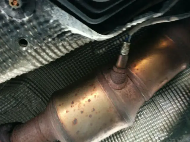 Podwozie Volvo z widocznym czujnikiem tlenu i katalizatorem, potencjalnie powiązane z błędem DTC P0420.