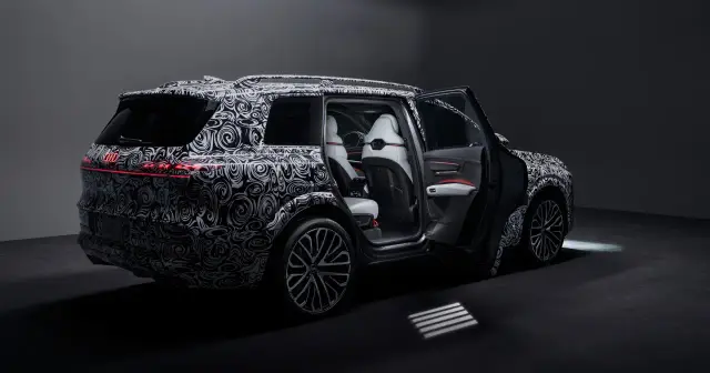 Prototyp Audi Q9 z otwartymi drzwiami, widoczne białe fotele i czerwone akcenty.
