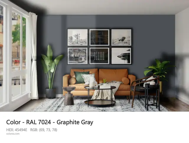 Nowoczesny salon w kolorze RAL 7024 jaki to kolor? Grafitowy, z pomarańczową kanapą i czarnymi ramkami na ścianie.