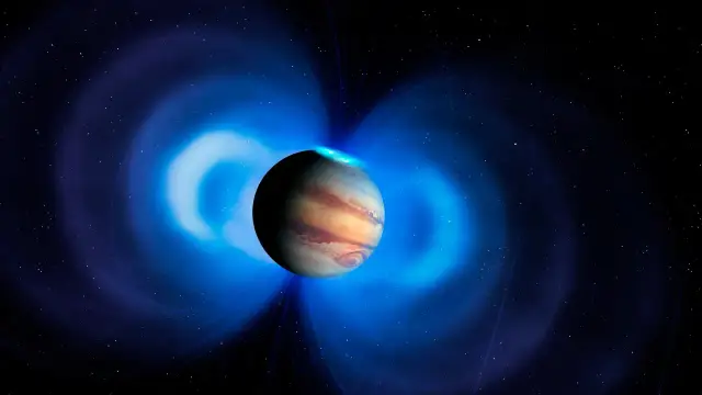 Największa planeta układu słonecznego, Jowisz, otoczona jest przez niebieskie pole magnetyczne i zorze polarne.