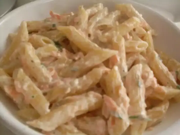 Penne cremose con salmone e panna, un piatto delizioso pronto per essere gustato.