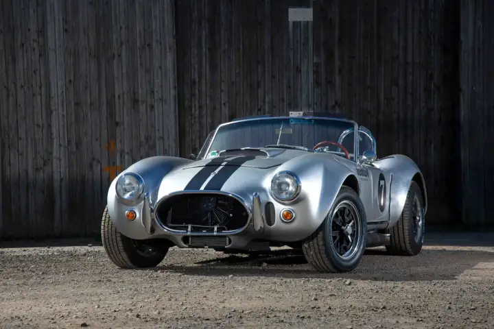 Silberner Cobra Shelby mit schwarzen Streifen, bereit für die Rennstrecke.