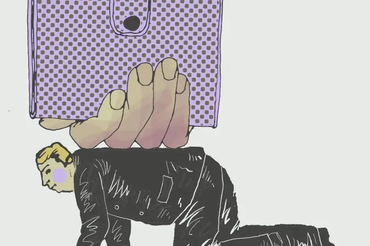 Dłoń z portfelem przygniata mężczyznę w garniturze. Czy to symbol tego, ile zarabia doktor na uczelni?