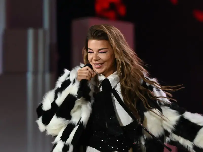 Edyta Górniak w szachownicznym futrze, z różowym makijażem oczu, śpiewa na scenie. Pamiętny występ na Eurowizji.