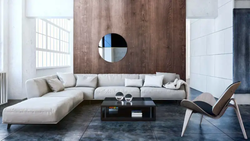 Nowoczesny salon w stylu bauhaus z szarą sofą, drewnianą ścianą i designerskim fotelem.