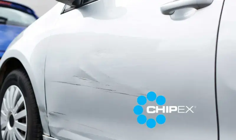 Scratches on a silver car door, with a CHIPEX logo. Can you buff out scratches like these?