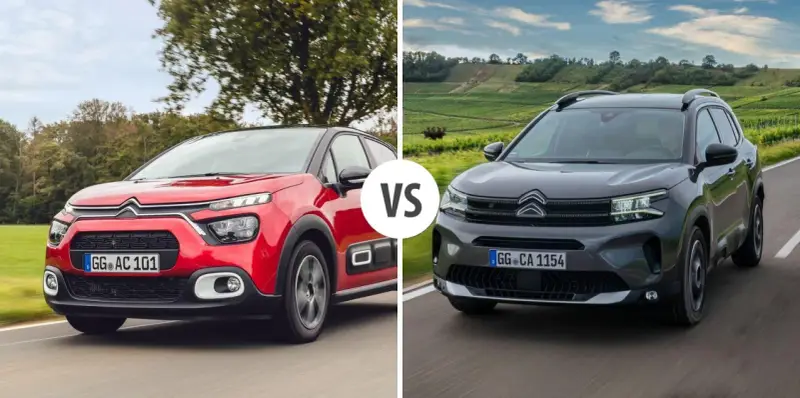 Dwa modele Citroen SUV: czerwony i ciemnoszary, jadące po drodze.