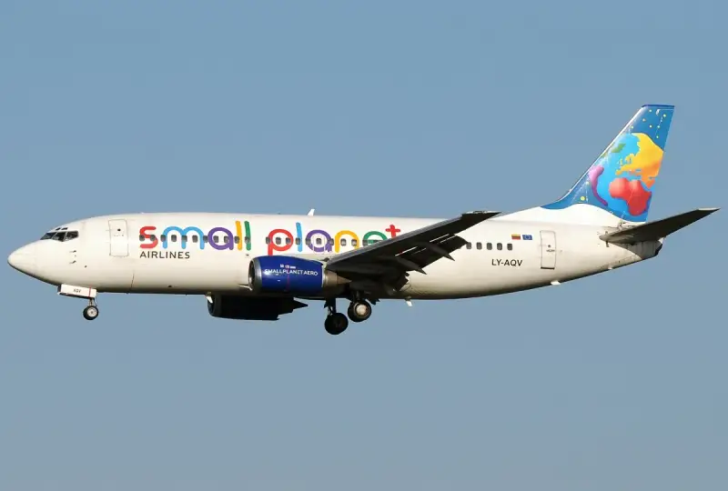 Samolot linii Small Planet Airlines z kolorowym motywem globu na ogonie.
