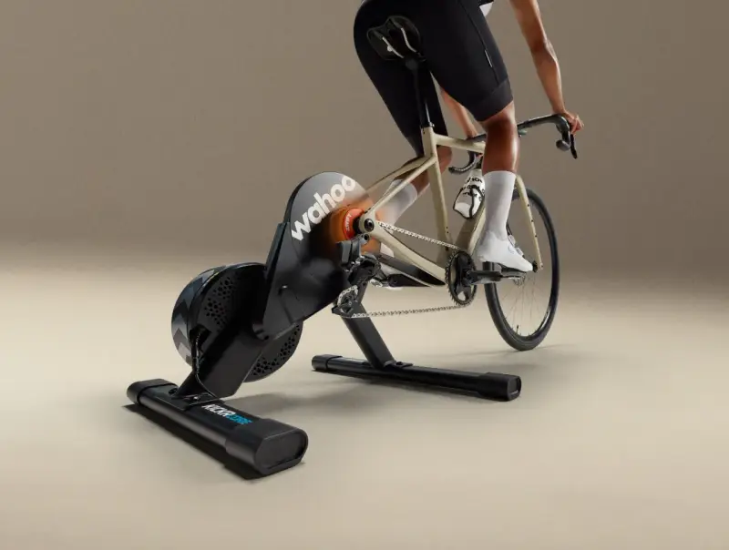 A cyclist rides indoors on a Wahoo Kickr Core 2 trainer, simulating an outdoor ride with realistic resistance.
