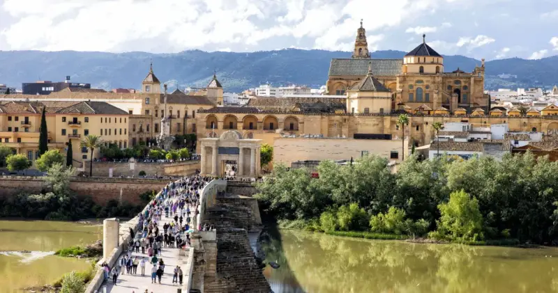 A bustling Roman bridge leads to the historic Mezquita-Cathedral of Córdoba. This view makes you wonder how many days in Córdoba are enough to explore its wonders.
