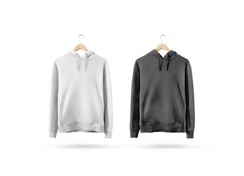 Dwie bluzy na wieszakach: biała i grafitowa. Idealne dla fanów popularnych marek bluz.